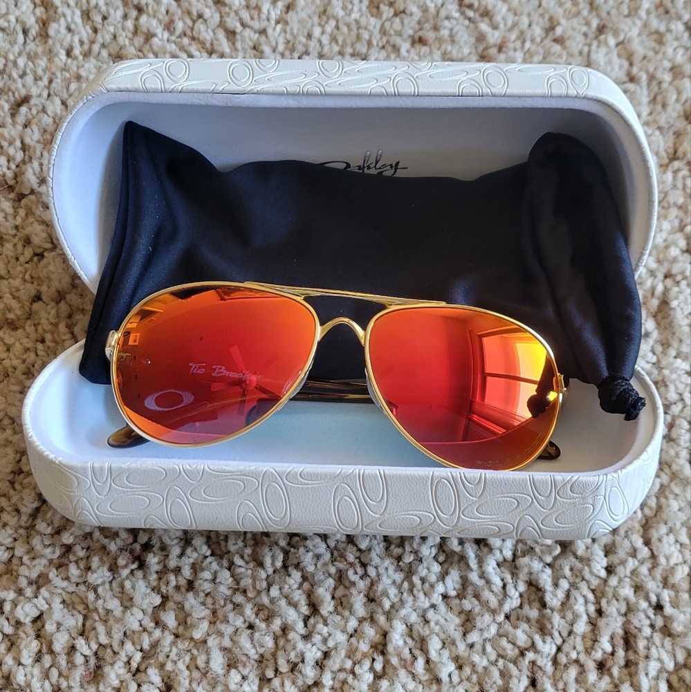 Woman's Oakley Tie Breaker Polarized Sunglasses- Gold Ruby color.